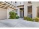 Exterior view of home featuring garage, front door, and desert landscaping at 11890 Tevare Ln # 1098, Las Vegas, NV 89138