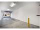 Bright two-car garage with an automatic door, lighting, and fresh paint at 11890 Tevare Ln # 1098, Las Vegas, NV 89138