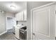 This laundry room boasts gray cabinetry, modern washer/dryer, and a convenient sink area at 11890 Tevare Ln # 1098, Las Vegas, NV 89138
