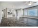 Spacious living room with gray walls, wood-look floors, and lots of natural light from multiple windows at 11890 Tevare Ln # 1098, Las Vegas, NV 89138