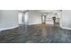Open-concept living space with modern flooring, neutral paint, and an adjoining kitchen area at 11890 Tevare Ln # 1098, Las Vegas, NV 89138