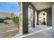 Covered patio with arched openings and view to the outdoor landscaping at 11890 Tevare Ln # 1098, Las Vegas, NV 89138
