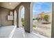 Covered patio with stucco arches and a view of the low-maintenance landscaping at 11890 Tevare Ln # 1098, Las Vegas, NV 89138