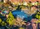 Aerial view showcasing a community pool with mature landscaping and several lounge areas at 11890 Tevare Ln # 1098, Las Vegas, NV 89138