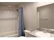 Modern bathroom featuring a shower/tub combo and a stylish granite vanity at 12800 Oceano Dunes Ct, Henderson, NV 89044