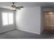 Bedroom features a window with shutters and doorway to bathroom at 12800 Oceano Dunes Ct, Henderson, NV 89044