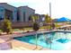 Community pool features sparkling water, a safety fence, and ample seating for relaxation at 12800 Oceano Dunes Ct, Henderson, NV 89044