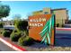 Entrance sign for Willow Ranch with lush desert landscaping at 12800 Oceano Dunes Ct, Henderson, NV 89044