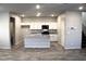 Modern kitchen with white cabinets, stainless steel appliances, granite countertops and a kitchen island at 12800 Oceano Dunes Ct, Henderson, NV 89044