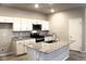 Bright kitchen featuring granite countertops, white cabinets and stainless steel appliances at 12800 Oceano Dunes Ct, Henderson, NV 89044
