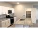 Modern kitchen with granite counters, stainless steel appliances, pantry and white cabinets at 12800 Oceano Dunes Ct, Henderson, NV 89044