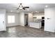 Open-concept living area and kitchen with tile floors, stainless steel appliances, and an island at 12800 Oceano Dunes Ct, Henderson, NV 89044
