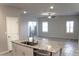 Bright kitchen featuring granite countertops, a center island, and an open concept to the dining area at 12800 Oceano Dunes Ct, Henderson, NV 89044