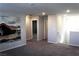 Bright loft area with neutral carpet, modern lighting, and desert themed art at 12800 Oceano Dunes Ct, Henderson, NV 89044