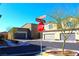 Modern homes at a corner with landscaped yards and convenient garages at 12800 Oceano Dunes Ct, Henderson, NV 89044