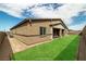 This virtually staged yard features desert landscaping, perfectly framing the modern home with a splash of green in the landscaping at 135 Barnett Crest Ct, Henderson, NV 89015