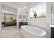 Spa-like bathroom with a modern soaking tub and a view into the main bedroom at 135 Barnett Crest Ct, Henderson, NV 89015