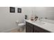 Clean, modern bathroom design, featuring tile floors, dark wood cabinets, and a large mirror at 135 Barnett Crest Ct, Henderson, NV 89015