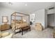 Bright bedroom with a canopy bed, sitting chair, and ensuite bath at 135 Barnett Crest Ct, Henderson, NV 89015
