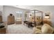 Spacious main bedroom featuring a canopy bed, sitting area, and neutral decor at 135 Barnett Crest Ct, Henderson, NV 89015