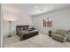Comfortable bedroom with a wooden bed frame, plush seating, and a window letting in natural light at 135 Barnett Crest Ct, Henderson, NV 89015