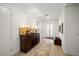 Bright foyer with light hardwood floors, front door, and dark wood credenza at 135 Barnett Crest Ct, Henderson, NV 89015