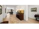 Hallway view featuring dark wood credenza with light hardwood floors and views into the home at 135 Barnett Crest Ct, Henderson, NV 89015