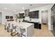 Bright kitchen with a large island, bar stool seating, stainless steel appliances, dark cabinets, and light wood floors at 135 Barnett Crest Ct, Henderson, NV 89015