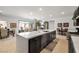 Open concept kitchen with stainless appliances, a large island, and a view of the dining and living area at 135 Barnett Crest Ct, Henderson, NV 89015