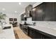 Modern kitchen with stainless steel hood, gas range, white marble backsplash, and light wood flooring at 135 Barnett Crest Ct, Henderson, NV 89015