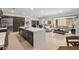 Modern kitchen with stainless appliances, a large island with a white countertop, and an open concept to the living area at 135 Barnett Crest Ct, Henderson, NV 89015