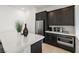 Modern kitchen with stainless steel appliances, dark wood cabinets, and bright white countertops at 135 Barnett Crest Ct, Henderson, NV 89015