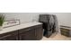 Well-organized laundry room with modern washer and dryer, sink, and counter space at 135 Barnett Crest Ct, Henderson, NV 89015