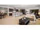Bright, open-concept living room and kitchen with modern cabinets, stainless appliances, and eat-in island at 135 Barnett Crest Ct, Henderson, NV 89015