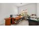Bright home office featuring sewing machines, large desk, and a window view at 135 Barnett Crest Ct, Henderson, NV 89015