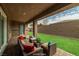 Cozy covered patio with comfortable seating and a view of the lush backyard at 135 Barnett Crest Ct, Henderson, NV 89015