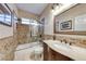 The bathroom includes a shower-tub combo with glass door, tiled walls, sink and mirror at 1983 Songbird Ct, Henderson, NV 89012
