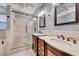 This bathroom features double vanities, and a glass enclosed shower and tiled flooring at 1983 Songbird Ct, Henderson, NV 89012