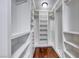 Walk-in closet with white shelving and wood flooring provides generous storage space at 1983 Songbird Ct, Henderson, NV 89012