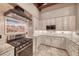 Gourmet kitchen featuring granite counters, stainless appliances, gas range and stylish backsplash at 1983 Songbird Ct, Henderson, NV 89012