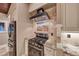 Gourmet kitchen featuring granite counters, stainless appliances, gas range and stylish backsplash at 1983 Songbird Ct, Henderson, NV 89012