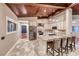 Gourmet island kitchen featuring granite counters, stainless appliances, a breakfast bar and wood ceiling beams at 1983 Songbird Ct, Henderson, NV 89012