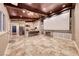 Bright living room with home theater screen featuring a stone fireplace, wood ceiling beams and travertine floors at 1983 Songbird Ct, Henderson, NV 89012