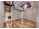 Open-concept living room with wood floors, tray ceiling, and natural light at 1983 Songbird Ct, Henderson, NV 89012