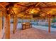 Outdoor kitchen with a grill, bar, tiki roof, and poolside dining area at 1983 Songbird Ct, Henderson, NV 89012