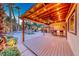 Backyard paradise with a covered deck, tiki bar and lush greenery at 1983 Songbird Ct, Henderson, NV 89012