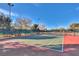 Well-maintained tennis court awaits players for a match, with a fenced perimeter and clear blue sky above at 1983 Songbird Ct, Henderson, NV 89012