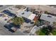An aerial perspective showcasing a single-story home with mature trees and a fenced yard at 2054 Harvard St, North Las Vegas, NV 89030