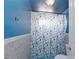 Blue bathroom featuring a shower-tub combo with seashell-themed shower curtain at 2054 Harvard St, North Las Vegas, NV 89030