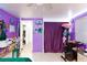 Purple bedroom featuring unique decorations, ample storage, and bright lighting at 2054 Harvard St, North Las Vegas, NV 89030
